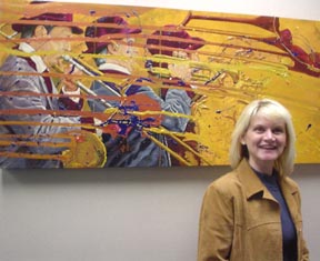 RELEASE OF SOULS Founder and Artist Kathleen Tonnesen in front of her earlier works:  Blown Away